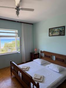 a bedroom with a bed with two towels on it at Hostel Guesthouse Mira in Omiš
