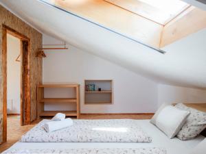a bedroom with two beds and a skylight at Apartment Vrhouc in Tolmin