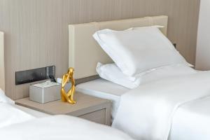 Tianmin Holiday Hotel Tianhe Dongpu Olympic Sports Center房間的床