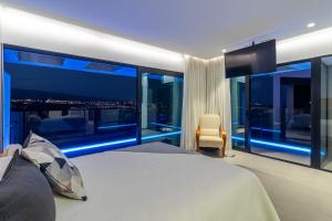 a bedroom with a view of a city at night at Villa Gold Star Meloneras in Meloneras +29 photos