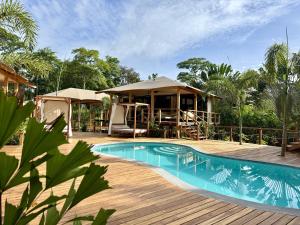 a resort with a swimming pool and a gazebo at Evia Life Resort in Puerto Viejo