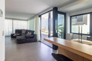 a living room with a couch and a table at Villa Gold Star Meloneras in Meloneras