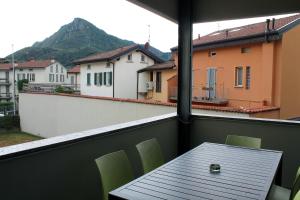 a view of a balcony with a table and chairs at COLOR HOUSE- Lecco's Lake in Lecco