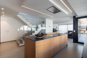 a kitchen with a large island with a counter top at Villa Gold Star Meloneras in Meloneras