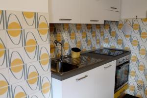 a kitchen with a sink and a counter top at COLOR HOUSE- Lecco's Lake in Lecco