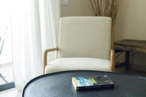 a book sitting on a table next to a chair at Casa Ilda in Olhão