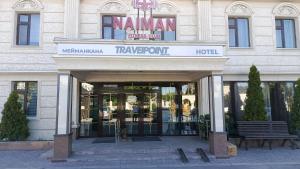 a building with a sign for a hotel at Travel Point hotel in Bishkek
