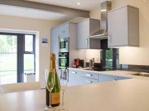 a bottle of wine sitting on a counter in a kitchen at The Garden Room At Eudon George in Shipton