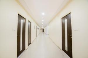 a corridor with black doors in a hospital hallway at Super Capital O Raaga Grand in Hyderabad
