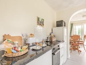 a kitchen with a counter top with a refrigerator at Ivy Cottage in Cumberworth