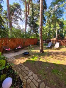a backyard with a fire pit and a fence at RECI Beach Cottage in Reci +38 photos