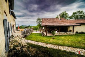 a house with a yard next to a building at À la campagne in Cezay