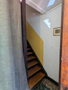 a staircase in a room with a curtain at Un étage entier dans une maison in Hinsbourg