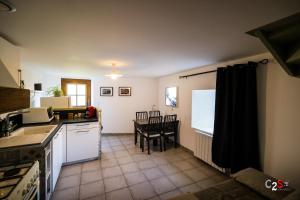 a kitchen with a table and a dining room at À la campagne in Cezay +8 photos