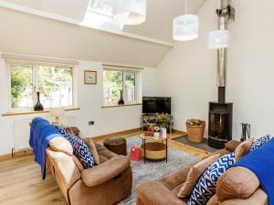 a living room with two couches and a fireplace at Woodlands in Milverton