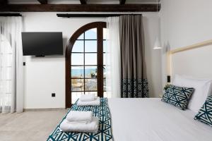 a bedroom with a large bed with a large window at Sea View Center 2 in Limenas