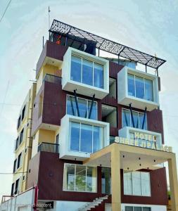 a building with balconies on top of it at Hotel Shree Ji Palace in Ujjain