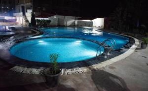 a large blue swimming pool at night at Chauhan Sheraton Resort in Pushkar +32 photos
