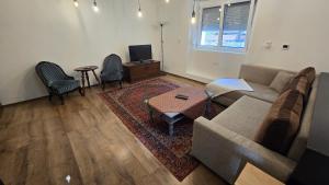 a living room with a couch and a table at Káli-lak Vendégház in Köveskál