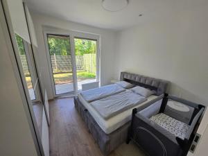 a bedroom with a bed and a large window at BA Apartment with free garage parking and garden in Bratislava +27 photos