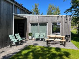 a patio with chairs and a table and a bench at Lofoten Holiday in Kabelvåg