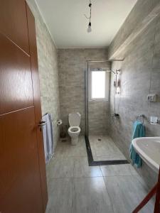 a bathroom with a toilet and a sink at Boho Breez Mountain View Chalet in Ras Elhekma +13 photos