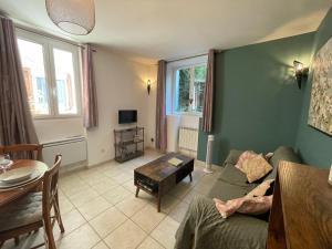 a living room with a couch and a table at La Conque Provençale in Flayosc
