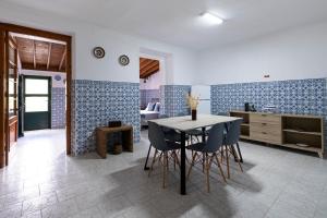 a kitchen and dining room with a table and chairs at Blue Tile Home in Furnas