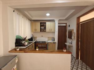 a kitchen with wooden cabinets and a counter top at Haven Homes in Nanyuki