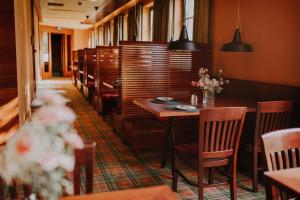 a dining room with a table and chairs at Hotel Wawrzyniak in Zduny