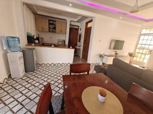 a living room with a couch and a table at Haven Homes in Nanyuki