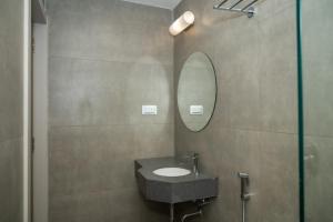 a bathroom with a sink and a mirror at Gold Inn Exotica in Bhubaneshwar