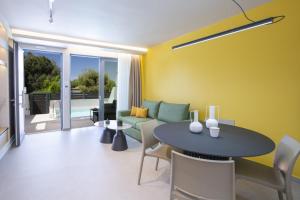 a living room with a table and a couch at Elysian Luxury Suite in Preveza