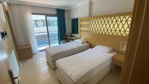 Postel nebo postele na pokoji v ubytování Aurasia Design Hotel