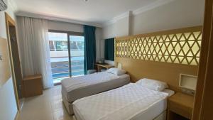 Postel nebo postele na pokoji v ubytování Aurasia Design Hotel