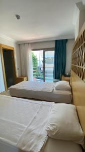 Postel nebo postele na pokoji v ubytování Aurasia Design Hotel