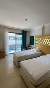 Postel nebo postele na pokoji v ubytování Aurasia Design Hotel