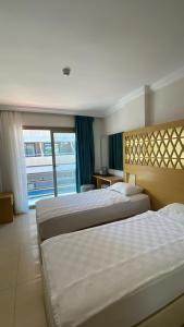 Postel nebo postele na pokoji v ubytování Aurasia Design Hotel