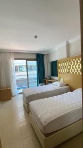 Postel nebo postele na pokoji v ubytování Aurasia Design Hotel