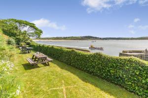 a park with picnic tables and a view of the water at 2 Bed in Padstow oc-t32456 in Padstow