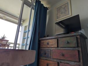 a television on top of a dresser in a room at La Kaz a lò in Le Diamant +17 photos