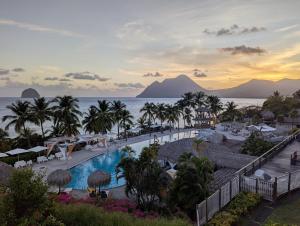 a view of the pool at the excellence kahala resort and spa at La Kaz a lò in Le Diamant