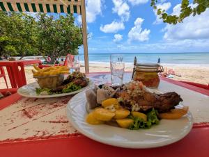 two plates of food on a table at the beach at La Kaz a lò in Le Diamant