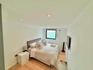a bedroom with a bed with pillows and a window at The Lookout-Sea Views-Balcony-Free parking in Ramsgate