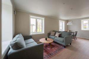 a living room with two couches and a table at Lofoten Summer Apartments in Kabelvåg