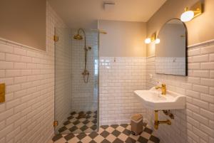 a bathroom with a sink and a shower at Lofoten Summer Apartments in Kabelvåg