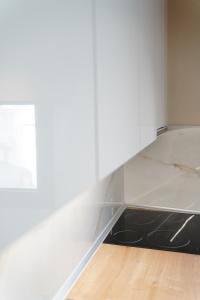 an empty room with a white wall and a table at Bright and central apartment in Siátista