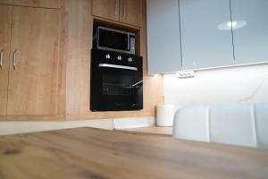 a kitchen with a black oven and a microwave at Bright and central apartment in Siátista