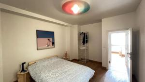 a bedroom with a bed and a red light on the ceiling at 201 Loft Lumineux en Hyper-Centre in Liège