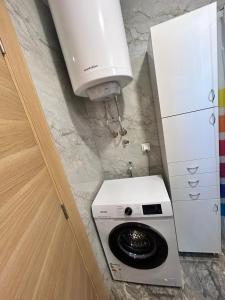 a washer and dryer in a corner of a room at ApartmanVID in Vrnjačka Banja +5 photos